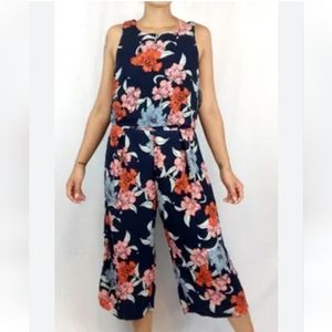 Floral cropped leg jumpsuit by GYPSIES & Moondust in a size Large